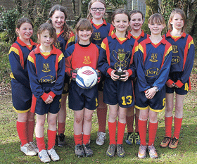 Shebbear U11s girls on ball at soccer tournament