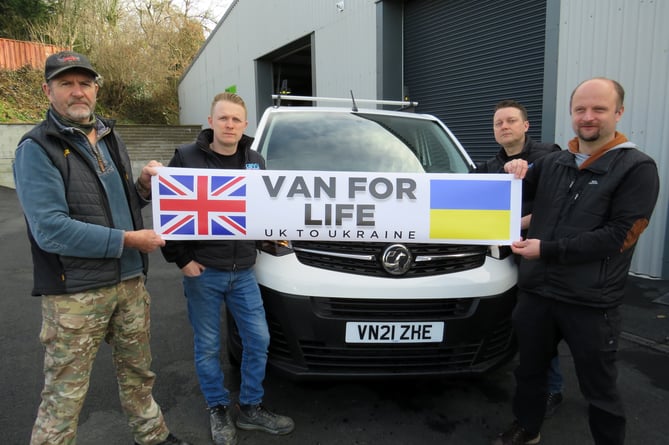                               Colin Clarke, Adam Wrobel, Ben and Dan Gerry from Tavy Signs with the Van for Life banner. Colin is appealing for funds to buy a van to take Ukrainian  refugees to safety 