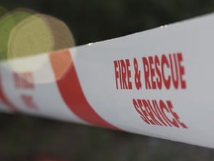 Firefighters tackle combine harvester on fire