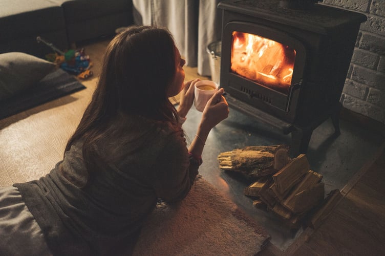 woman in front of woodburner