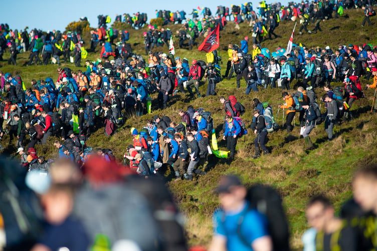 Pictured;
The mass start of Ten Tors 2019 as they walk down a very steep hill.
TEN TORS AND JUBILEE CHALLENGE (EXERCISE WYVERN TOR) 2019
As well as a vital high-level military resilience exercise - called Exercise WYVERN TOR - The Ten Tors Challenge is also one of the biggest outdoors adventure events for young people in Britain today. In all, 2400 youngsters aged between 14 and 19 will take part in Ten Tors, with a further 300 youngsters with physical or educational needs taking part in the Jubilee Challenge.
The majority of the teams who enter Ten Tors are from schools and youth groups from across the South West. These include scout groups, sports and ramblersÕ teams and Armed Forces cadet units, all of whom have trained hard over the last few months and are ready to accept the challenge!
Those teenagers taking part will trek unaided over different 35, 45 or 55 mile routes and will encounter some of the toughest terrain and highest peaks in Southern England. They will rely on their navigational skills and will carry all their food, water, bedding, tents and other essentials as they go. It is a feat they must complete as a team and without any help from adults and theyÕll remain entirely self-sufficient during their arduous expeditions, including camping out overnight on the moor.
One of the most enduring legacies of Ten Tors is a lasting appreciation of the beauty of Dartmoor which is instilled in every young person taking part. For some it may be the first time they have spent any length of time walking in the countryside. For many it is sure to ignite a passion for the outdoors which stays with them forever. But for all it is something theyÕll never forget, and team managers are guided to encourage participants to develop respect and appreciation for the landscape, cultural heritage and wildlife of Dartmoor.
Photographer:
CPL BEN BECKETT RLC /MoD Crown Copyright