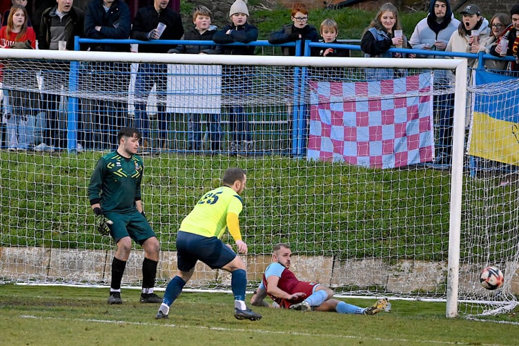 Farnham’s Tom Smith clears off the line in the last minute