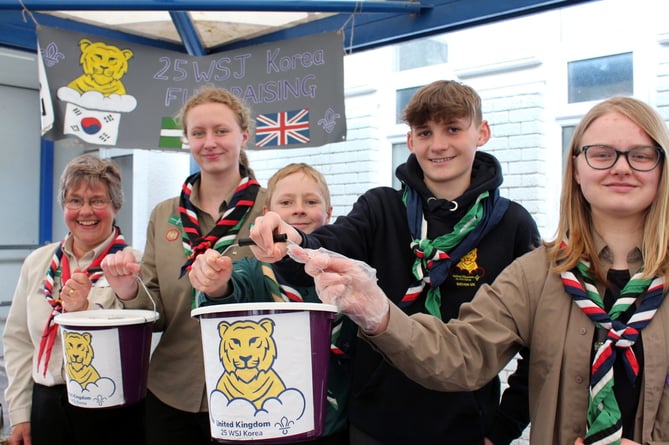 Raising funds for their trip to the World Scout Jamboree in South Korea in August were Linda Atouguia (District Unit Leader) with Ruby Brown and Sam Carling (both Okehampton), Sophie Cooper (Mid Devon Tigers) and James Cooper (Bow). 