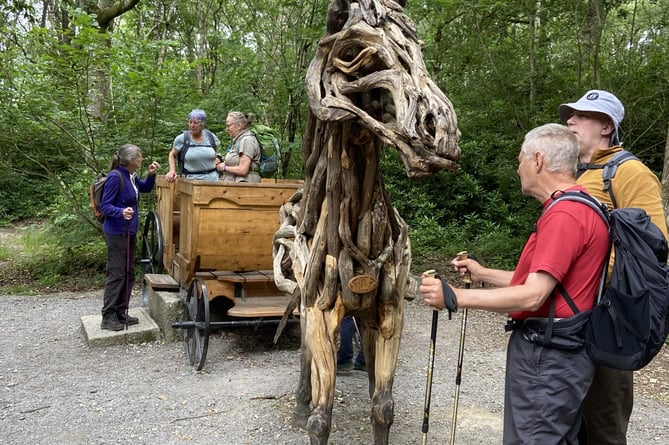 Okehampton ramblers contemplate  the Horse and Carriage sculpture