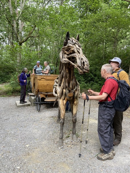 Okehampton ramblers contemplate  the Horse and Carriage sculpture
