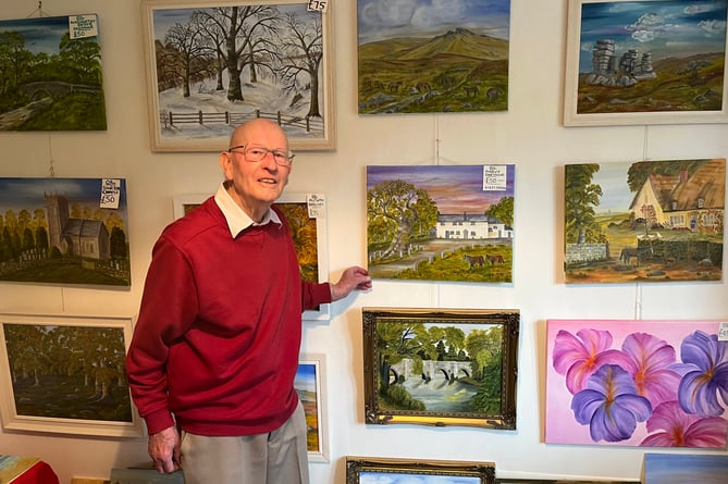 Alec Davey with his paintings