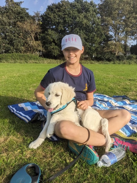 Nevah Richards with her golden retriever puppy Coco