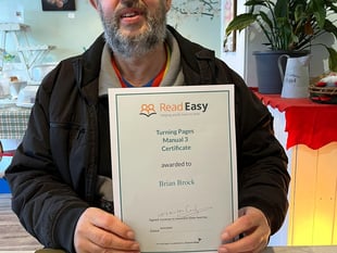 Brian earns certificate for next stage of Read Easy course