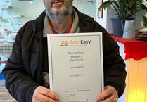 Brian earns certificate for next stage of Read Easy course