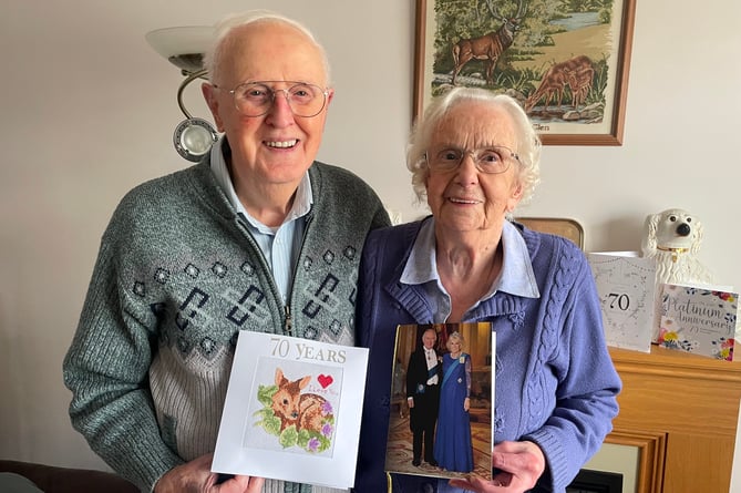 Reg and Hazel Kingsland with their card from the King and Queen on their Platinum Wedding Anniversary and a cross-stitch card Reg had made for his wife to mark the occasion.  AQ 3286
