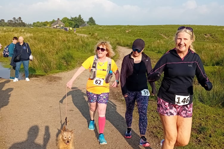 Dotty King (left) and her four-legged faithful companion and friends on the Princetown Fire Station trail race.