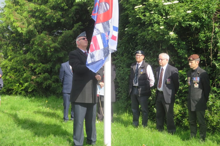 Retired RAF Corporal Ian Mansfield hoisting flag