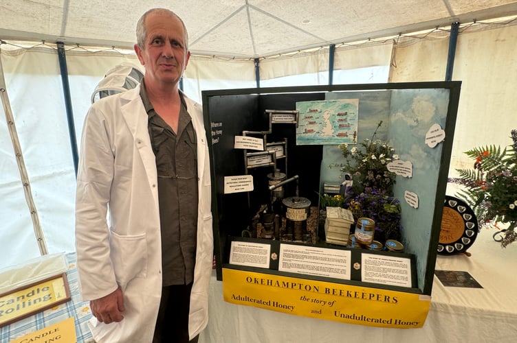 Simon O'Sullivan beside the Okehampton Beekeepers story about real honey.