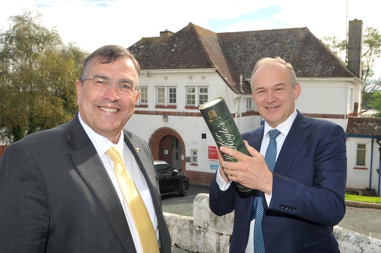 Liberal Democrat leader Ed Davey visits Teignbridge. Ed Davey signs a bottle of House of Commons whisky to be auctioned off for charity with Newton Abbot MP Martin Wrigley