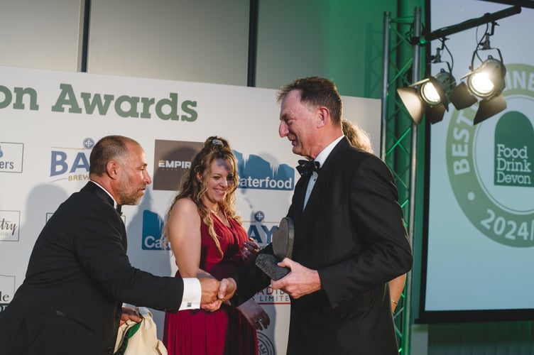 Adam Fox-Edwards from Devon Hampers accepting his award from Greg Parsons of Food Drink Devon
