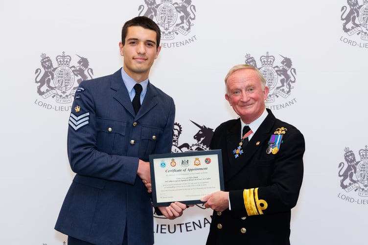 Flight Sergeant Giles Pahdi of 2443 (Okehampton) Squadron at his investiture at County Hall. Deputy lord lieutenant Rear Admiral Chris Snow presents him with his certificate