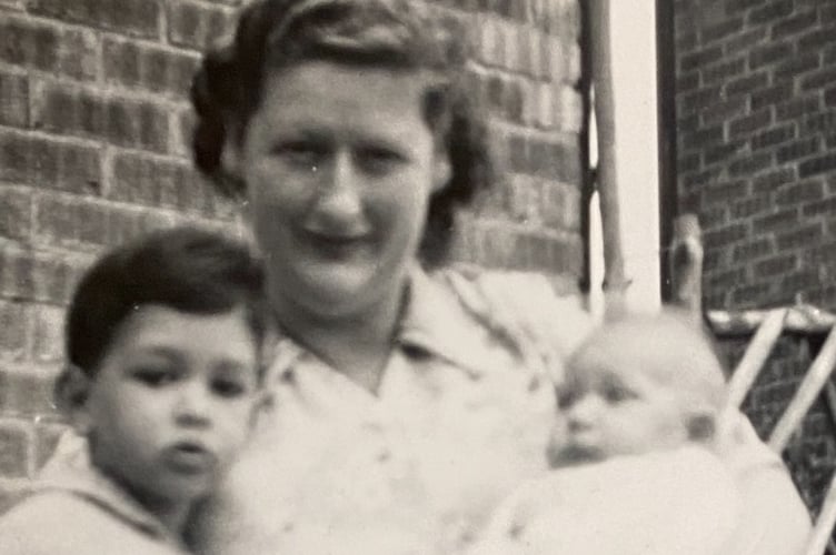 Baby Christine Rickard in her adoptive mother Peggy's arms with adopted brother Phil
