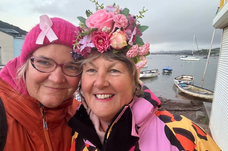 Mary Miles in the floral hat with another Teignmouth Mermaid raising awareness of breast cancer
