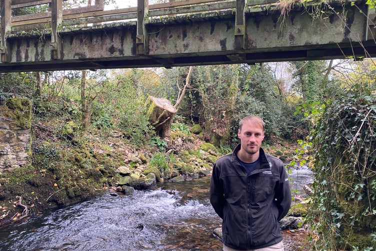 James McGahey and one of the restored bridges at Simmons Park.