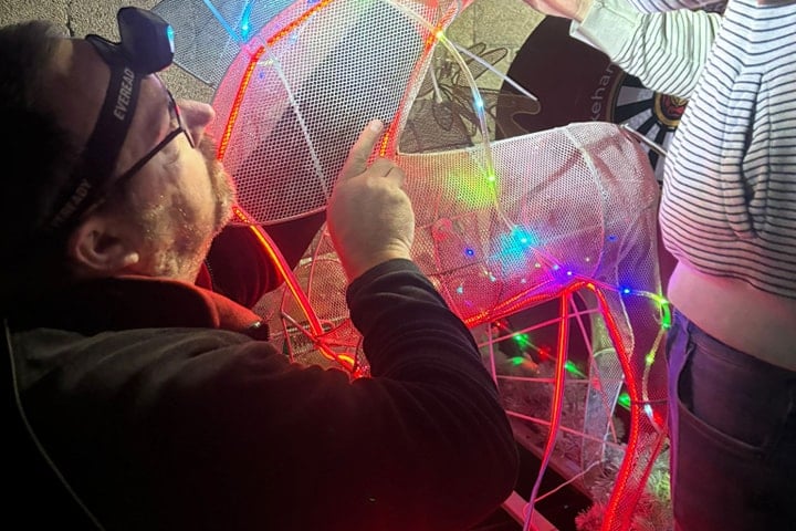 Okehampton Round Table members fixing the Christmas sleigh