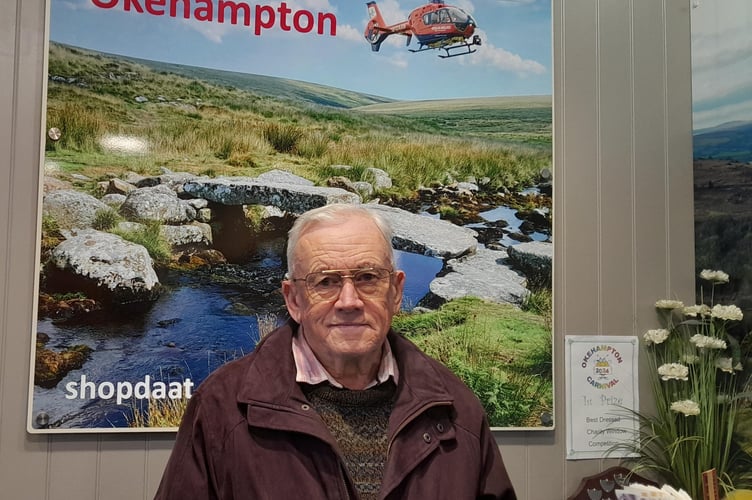 Michael Scully at the Okehampton Devon Air Ambulance shop with his  £500 cash donation