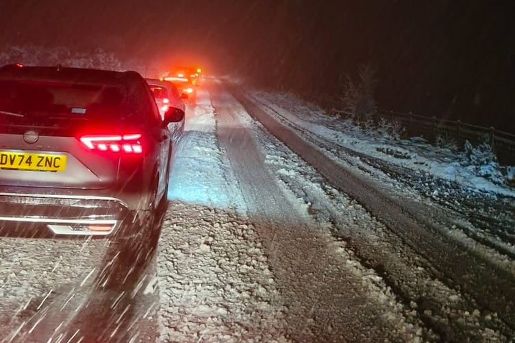Traffic struggling through a snow storm last night between Mary Tavy and Belstone.