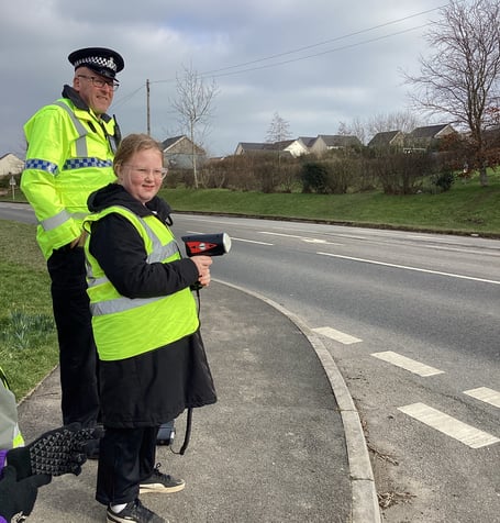 Police and volunteers conducting a speed monitoring session on the Crediton Road outside St James' Primary School.