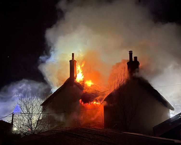 Firecrews at the scene of the thatched property fire in Drewsteignton.
Photo:  The Drewe Arms Community Pub/Facebook