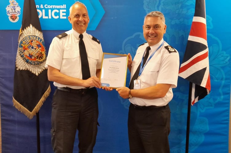 Superintendent Toby Davies (left) receives his retirement award from Devon & Cornwall Police Chief Constable Vaughan