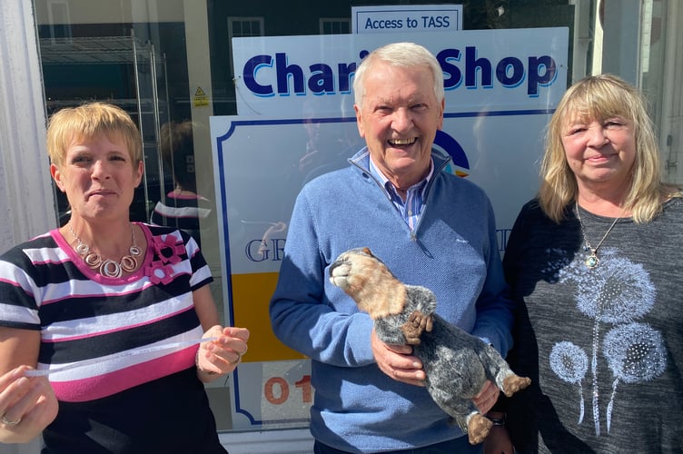 The TASS charity shop is opening up in a new Tavistock town centre temporary location after being forced to move by storm damage. Deb Morris TASS manage) ad businessman John Taylor and Deborah  Holland, shop manager, at the new site with charity mascot.