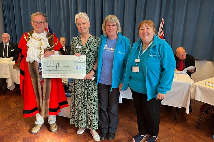 Cllr Fisher giving a cheque of over three thousand pounds to Hospiscare.