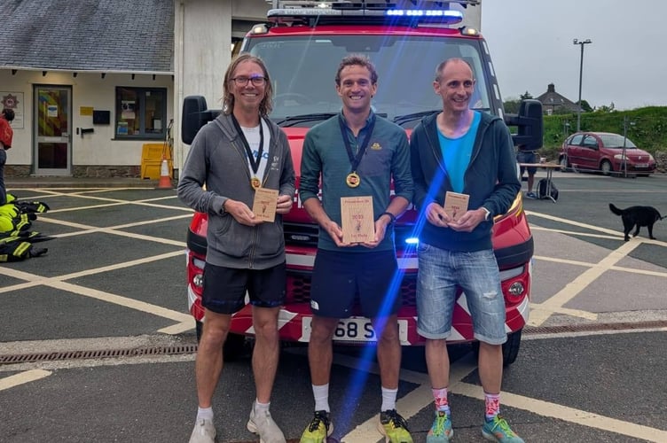 Princetown Firefighters Charity 10km race winner Theo Burgess (centre) and second and third males  John Terry and Kevin Watkinson.