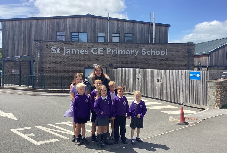 Headteacher Maria Hazelwood with some of the children outside St James Primary, Okehampton.