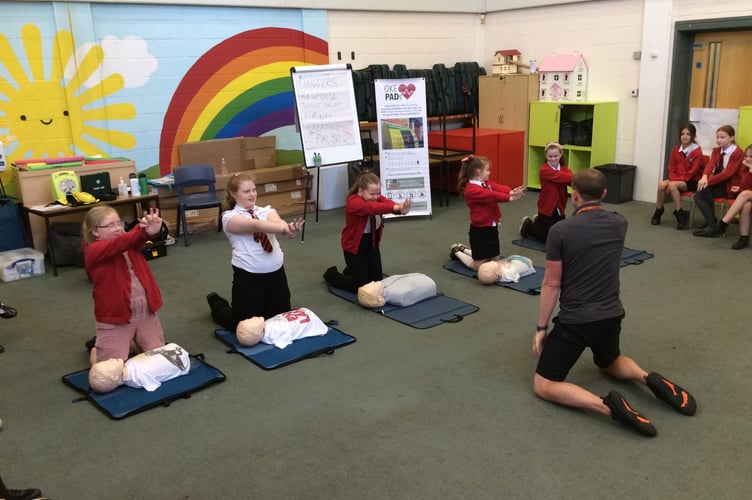 Joe Rice teaching Okehampton Primary School pupils how to perform CPR.