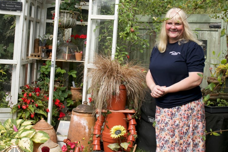 Claire White is rightly proud of her and husband Mark's admired floral home in Lamerton which has a myriad selection of mini-gardens at the back and greenhouses.Picture by Jude Wright.