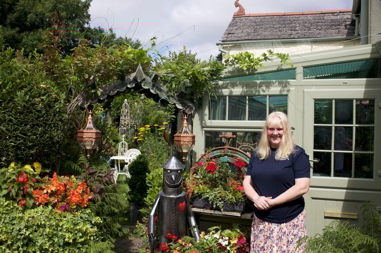 Mark and Claire White are proud of their admired floral home in Lamerton which is equally pretty in the back garden. Picture by Jude Wright.