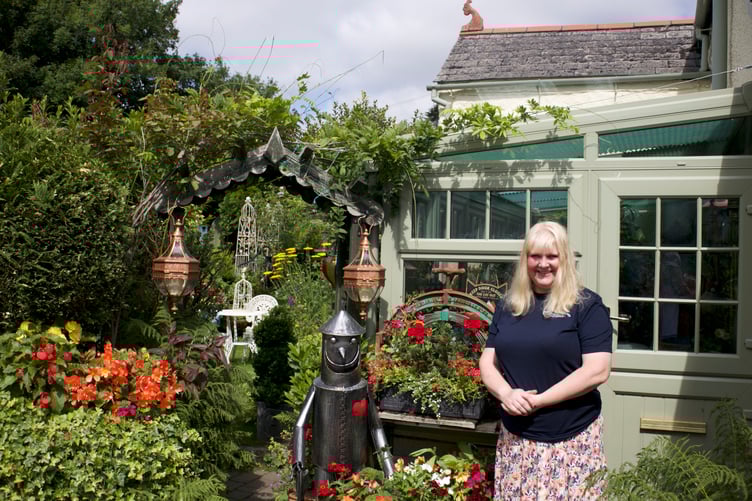 Mark and Claire White are proud of their admired floral home in Lamerton which is equally pretty in the back garden. Picture by Jude Wright.