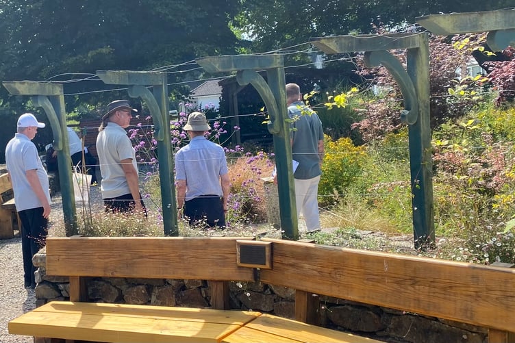 Rob Smith, head gardener at Tavistock Sensory Garden, shows Royal Horticultural  Society judges the blooming delights of the community beds.