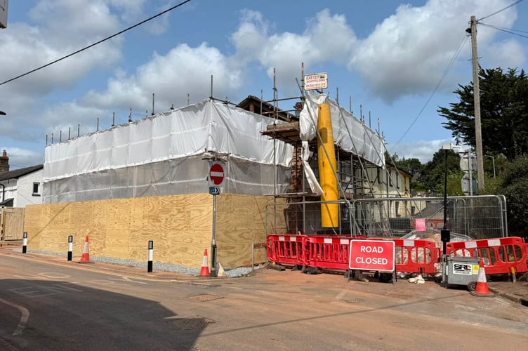 Hoarding and Bewsley Hill road closure at The Cross Hotel site in Copplestone