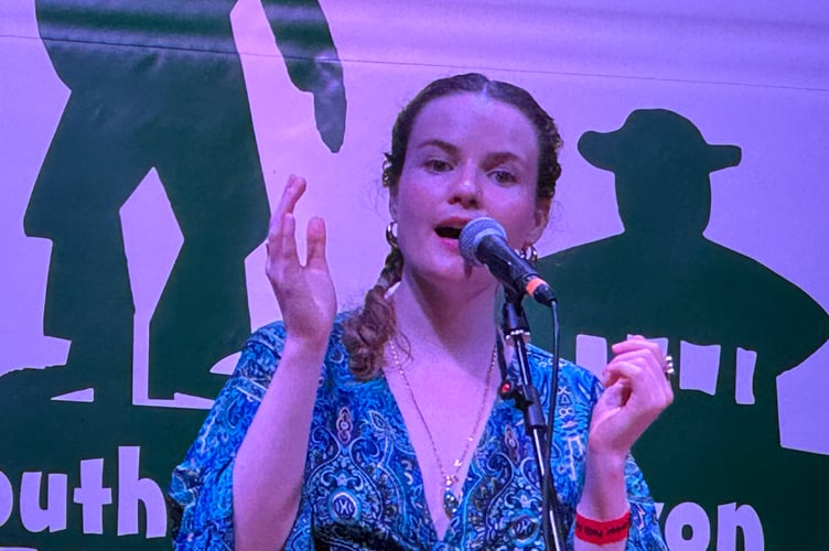 Detta Kenzie on stage at the 2025 Dartmoor Folk Festival. AQ 9375