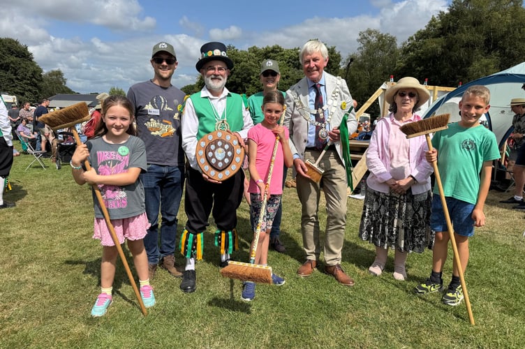 The Dartmoor Broom Dance winner, centre and runners-up, left and right, with the judges and the Mayor of West Devon, Cllr Paul Vachon and Exeter Morris Squire Dave Minty, who presented the awards. AQ 9040