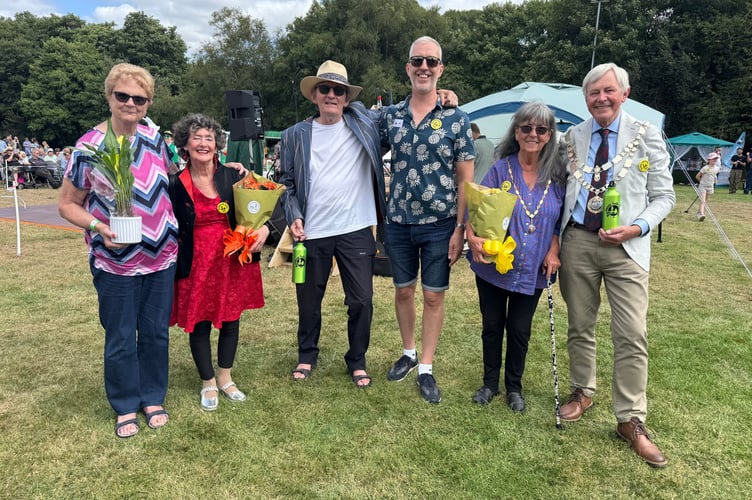 Pete and Sue Coe opened the Dartmoor Folk Festival, second and third left, with Festival President Shirley Bazeley, left and from fourth, Jason Rice, festival chairman and the Mayor of West Devon, Cllr Paul Vachon, right and Mrs Lynn Vachon. AQ 8948
