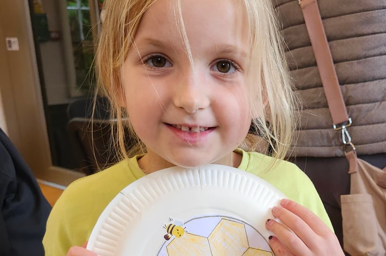 A young girl learning about honey while uncovering Tavistock's history through art and play.