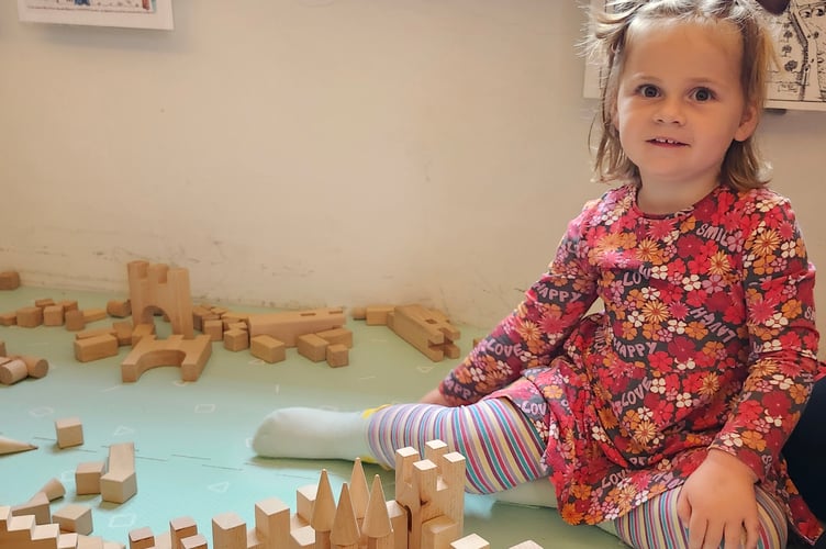 A young girl learning about castles while uncovering Tavistock's history through art and play.