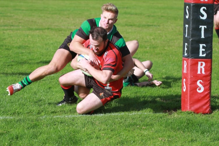 Fly half Chris Watts scores by the post for the Moorlanders.