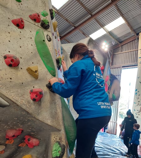 Lifton Primary School pupil rising to the challenge on a climbing wall.
