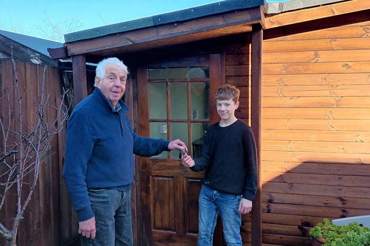 Phil Bush from Okehampton Men in Sheds hands Jonathan the keys to his new shed, built for him by the 'shedders'.