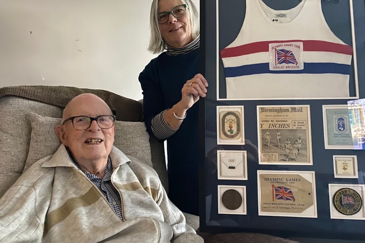 Mike Farrell and his daughter Sarah French with his treasured Melbourne Olympics memorabilia.
