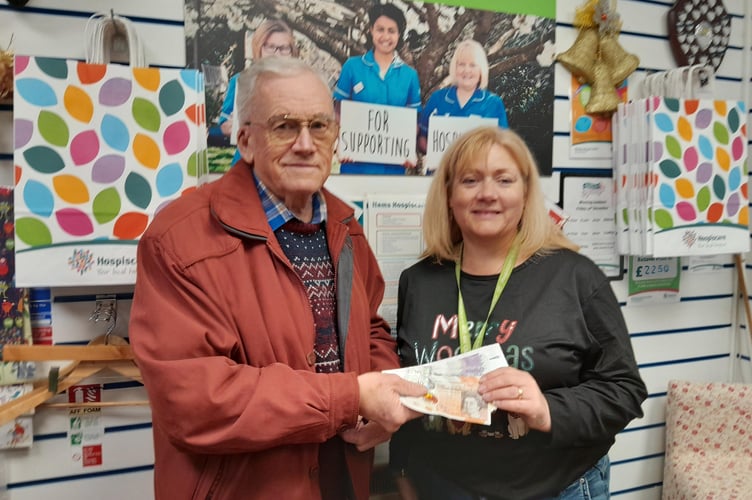 Michael Scutt of Viewfinder Tours in Sourton handing over a £600 cheque from his charity raffles  to Okehampton's Hospiscare shop.