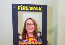 Okehampton Specsavers employee walks on fire to raise £600 for Hospiscare